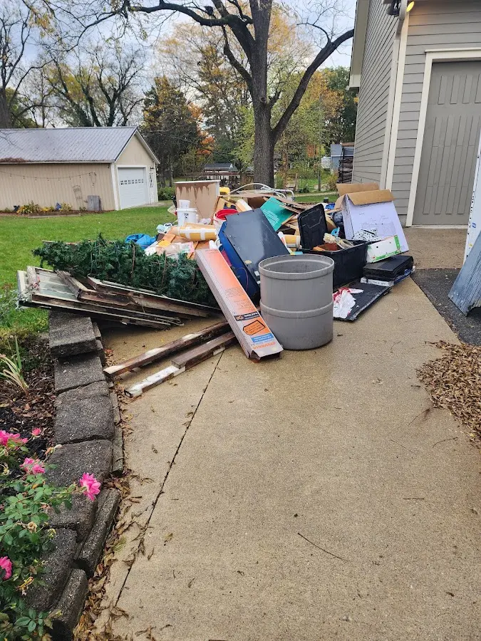 Dumpster being loaded with debris for 12 Yard Dumpster Rental in Newstead